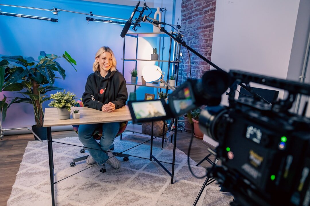 Camera operator filming a reporter interviewing a guest in a studio