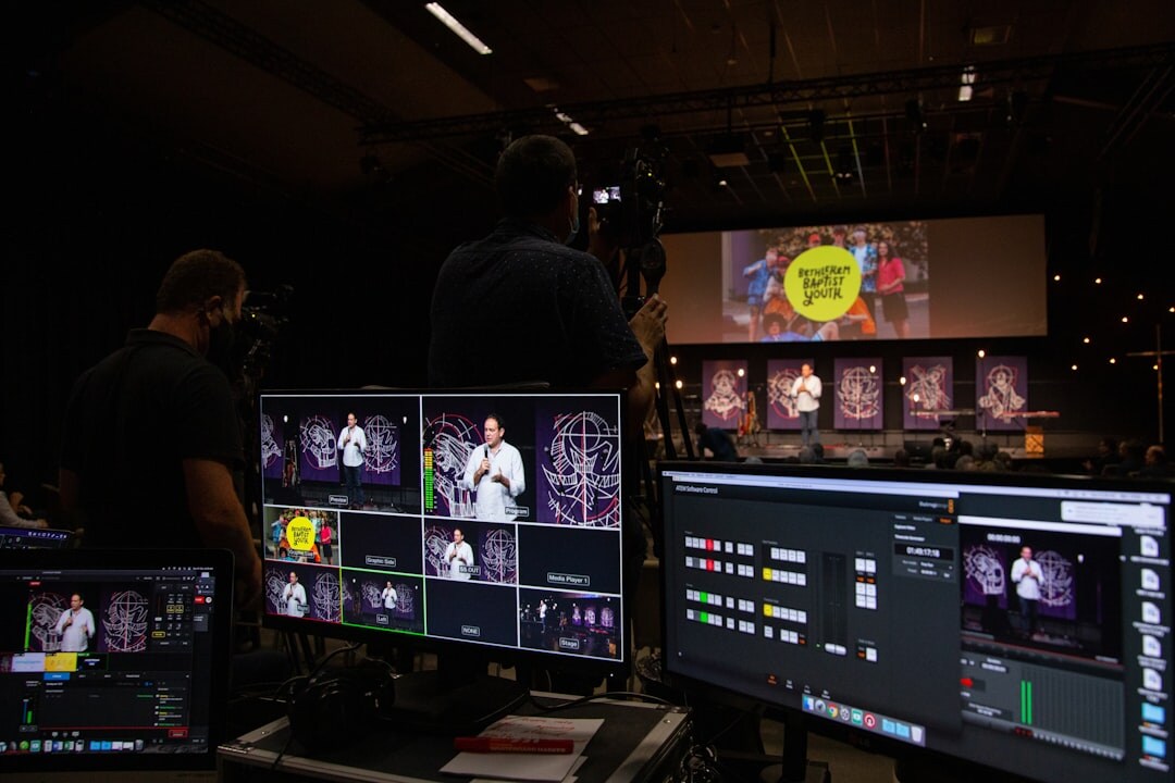 Broadcast production team reviewing footage on a large screen