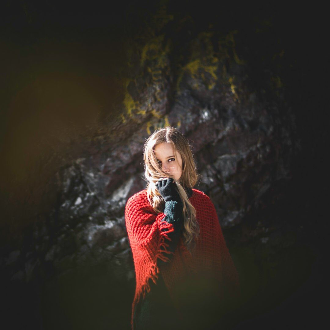 Portrait of a young female journalist holding a microphone